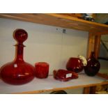 A mixed lot of ruby glass including art glass ashtray, brandy glass with cat and mouse etc.,