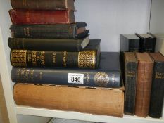 A shelf of old books including Bibles.