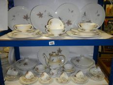 A Royal Doulton 'Tumbling Leaves' dinner set with tureens, soup bowls etc.,