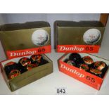 Two boxes of Dunlop golf balls, unused.