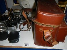 A vintage Exakta camera with lenses and case.