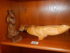 A carved wood lizard and mouse.
