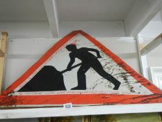 A large vintage road works sign.