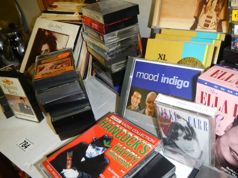 A varied selection of music cassettes and 45 rpm records. - Image 2 of 3