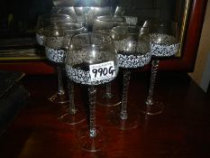 A set of six twist stem wine glasses.