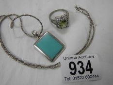 A silver 925 pendant and a costume ring.