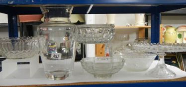 Four glass fruit bowls and a vase.