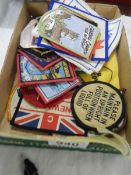 A quantity of vintage cloth tourist badges.