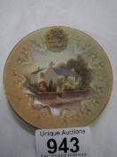 A small early Royal Worcester 'Dove Cottage Grasmere' hand painted plate, 8.25 cm diameter.