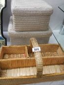 A vintage wicker cutlery basket and two lidded wicker boxes.