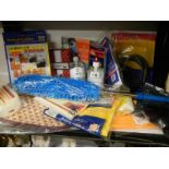 A shelf of miscellaneous including dusters, gloves, sterile sanitizer etc.,