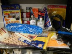 A shelf of miscellaneous including dusters, gloves, sterile sanitizer etc.,
