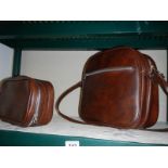 A brown leather shoulder bag and one other.