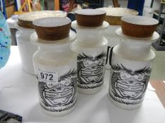 Three Port Merion Susan Williams-Ellis dolphin pattern storage jars and two others.