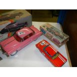 A boxed tinplate friction 1950's Cadillac and a clockwork rally car.