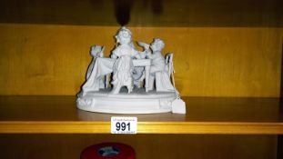 A mid 20th century Parian figure depicting a children's tea party.