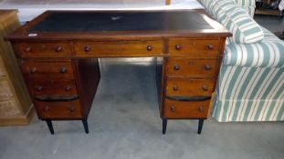 An Edwardian mahogany veneered double pedestal desk with leather insert, 59cm x 120cm x 79cm high.