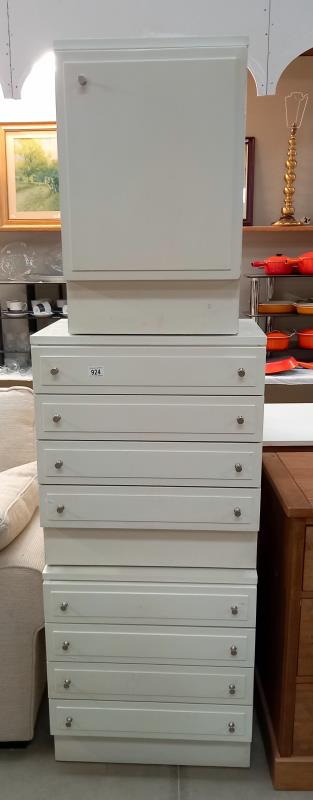 A pair of STAG white 4 drawer chest of drawers & a beside cupboard