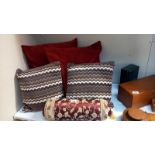 4 cushions and a bolster cushion