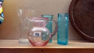 A quantity of coloured glass vases/jugs