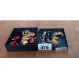 A quantity of decorative brooches including cats, dog & apple etc.