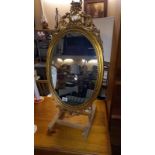 A gilt ormalu framed oval mirror, 40cm x 76cm (stand not included), COLLECT ONLY