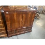 A dark wood stained television cabinet 97x54x H96cm