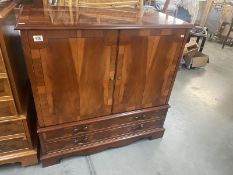 A dark wood stained television cabinet 97x54x H96cm