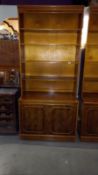 A dark stained open bookcase with walnut veneered doors, 95cm x 53cm x 210cm high, COLLECT ONLY