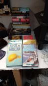 A quantity of fiction books by thriller and adventure writer Alistair Maclean among others