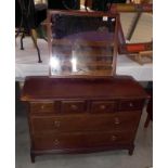 A dark wood stained mirror back dressing table, 107cm x 47cm x 72cm high. Mirror height 128cm,