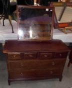 A dark wood stained mirror back dressing table, 107cm x 47cm x 72cm high. Mirror height 128cm,