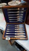 An oak cased silver plate set of fish knives and forks by Cross Bros Cardiff