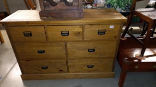 A dark pine 3 over 4 chest of drawers, 125cm x 45cm x 83cm high, COLLECT ONLY