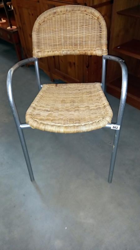 A metal framed chair with wicker seat & back panel, COLLECT ONLY