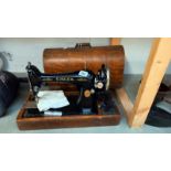 A cased vintage Singer sewing machine COLLECT ONLY