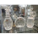 Three unusual shaped glass decanters.