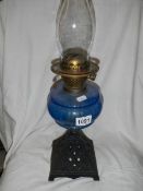 An early 20th century oil la,p with blue glass font.