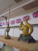 A brass door stop and a cast metal squirrel door stop.