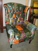 A wing armchair with multi coloured upholstery, COLLECT ONLY.