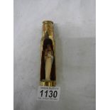 A item of trench art being a gun shell with figure of the Virgin Mary inside.