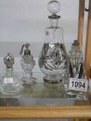 A large old perfume bottle and three smaller examples.