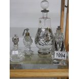 A large old perfume bottle and three smaller examples.