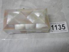 A mother of pearl stamp box, in good condition.