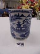 An early 20th century blue and white tankard with cane handle (a/f chips to top rim).