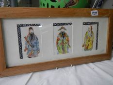 A framed and glazed set of three Chinese watercolours of Chinese gentlemen in one frame.