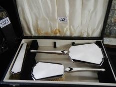 A cased part art deco dressing table set.