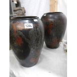 A pair of tall bronze vases marked WMF 11.737A