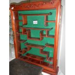 A Chinese mahogany display cabinet with shaped shelves.