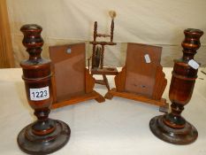 A pair of Edwardian wooden photo frames, pair of wooden candlesticks and a miniature spinning wheel.